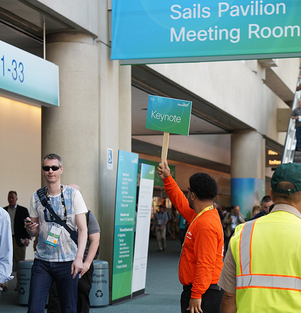 Cisco employee holding a sign for John Chambers keynote CLUS 2015