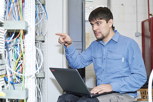 bad network stock photos: technician pointing at a rack