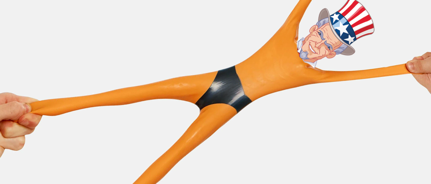 Stretch Armstrong toy, wear Uncle Sam's head, is stretched out by hands on each limb.
