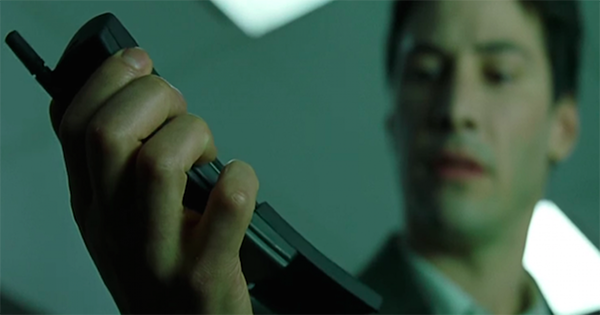 Neo holding a phone