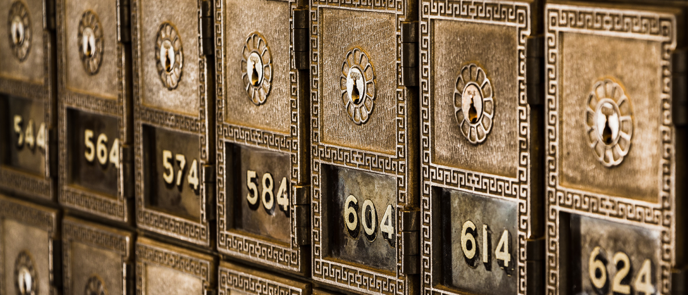 A line of old brass mailboxes