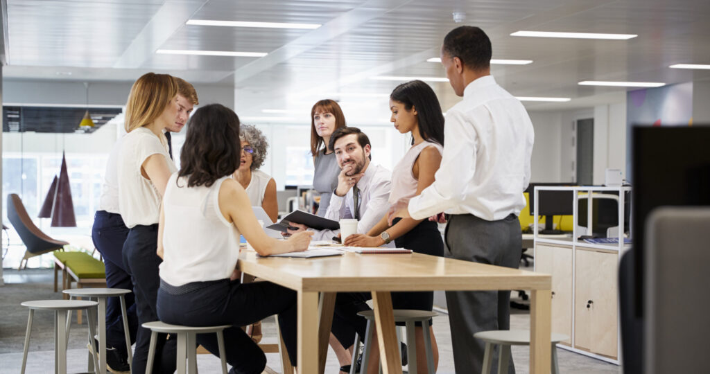 IT colleagues meeting together around a table